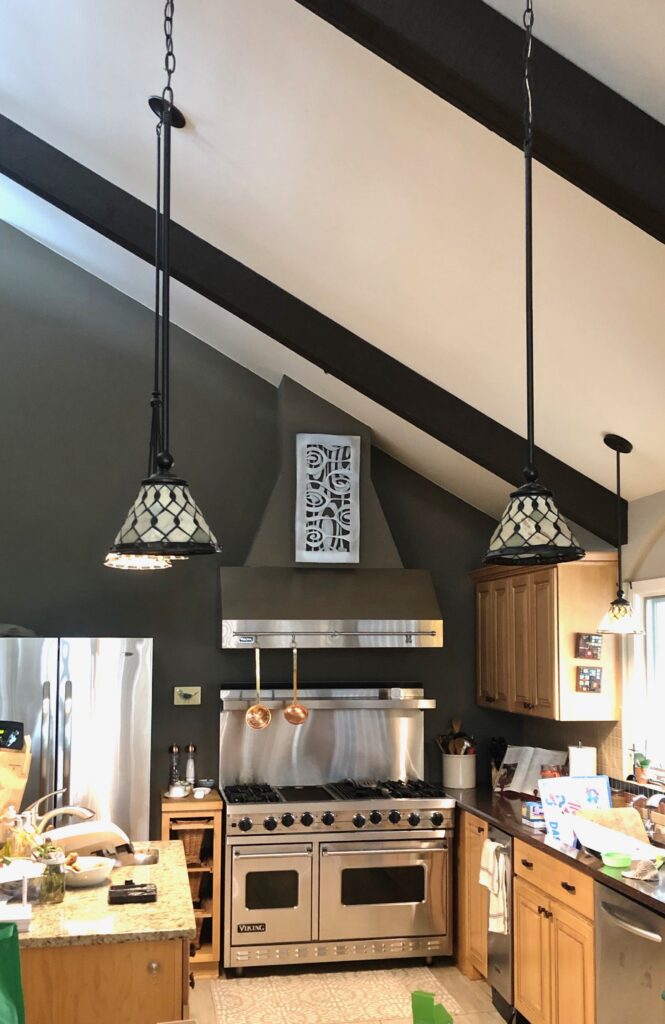 Onion Wall Tile hanging above the range in a tall-ceiling-kitchen.