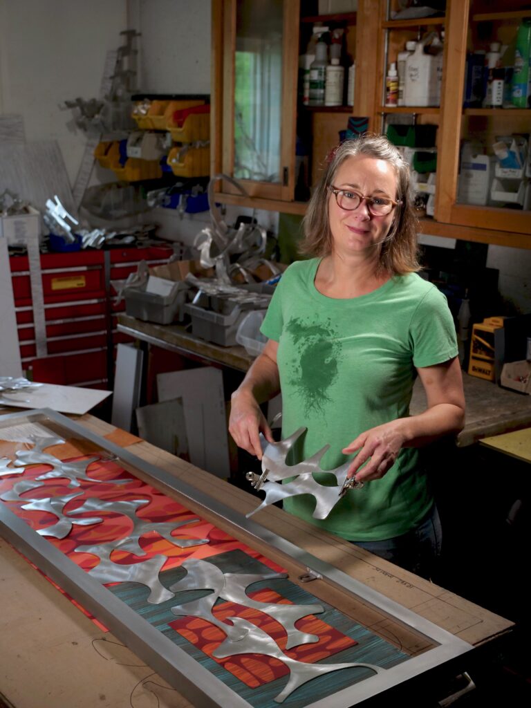 Cherie Haney laying out a wall sculpture in process