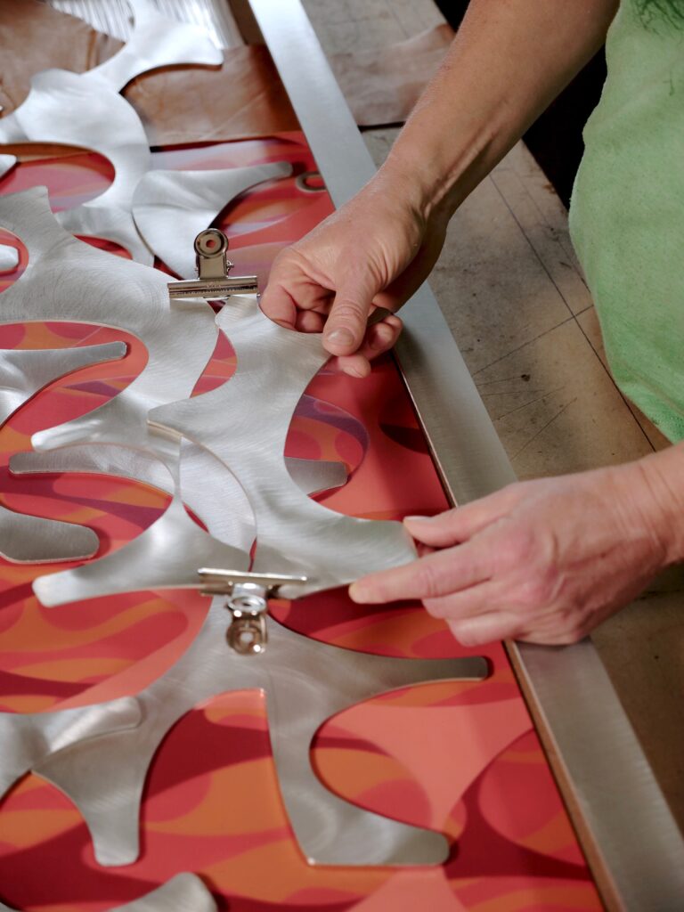 Cherie Haney fitting metal pieces into an attractive design