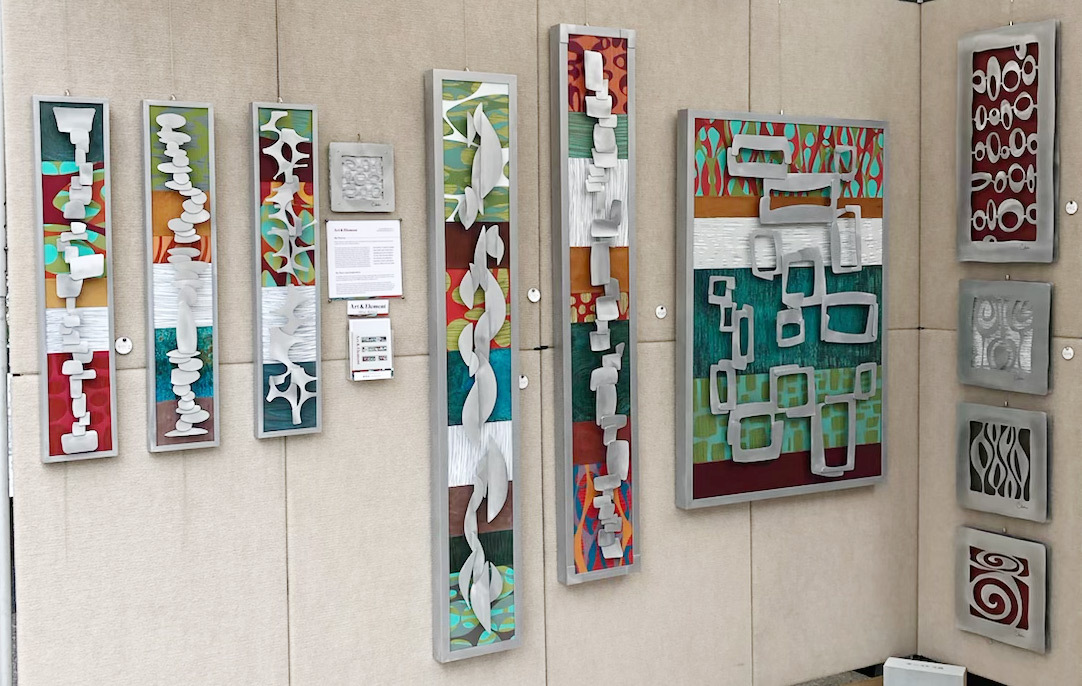 metal art on a festival booth wall