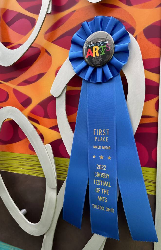 Cherie Haney's Crosby Festival award for Best of Category in 2022, affixed to a metal art wall sculpture