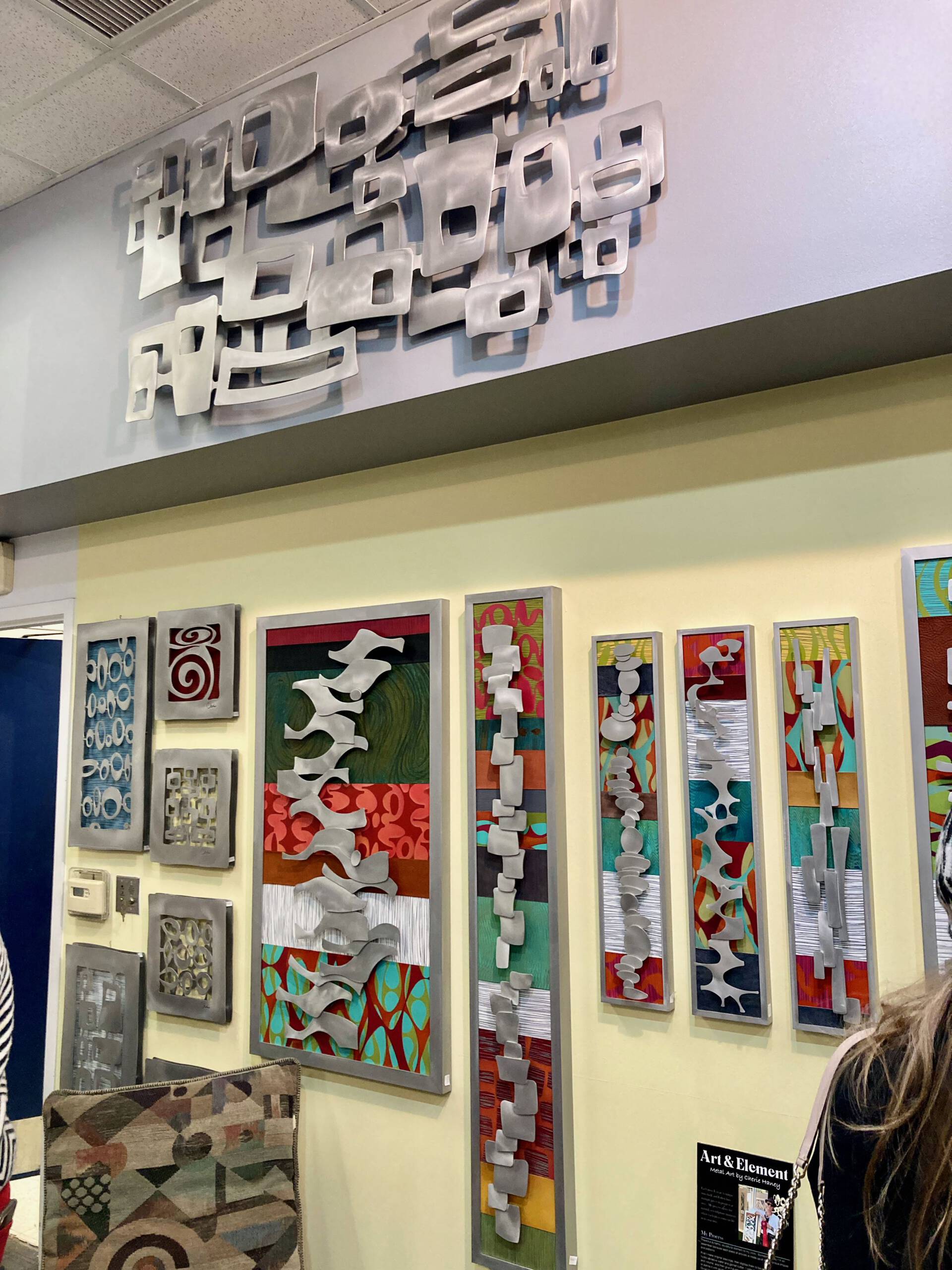 a wall full of handmade fine art wall sculptures from Cherie Haney, on display at the Makeshift Gallery in Ann Arbor