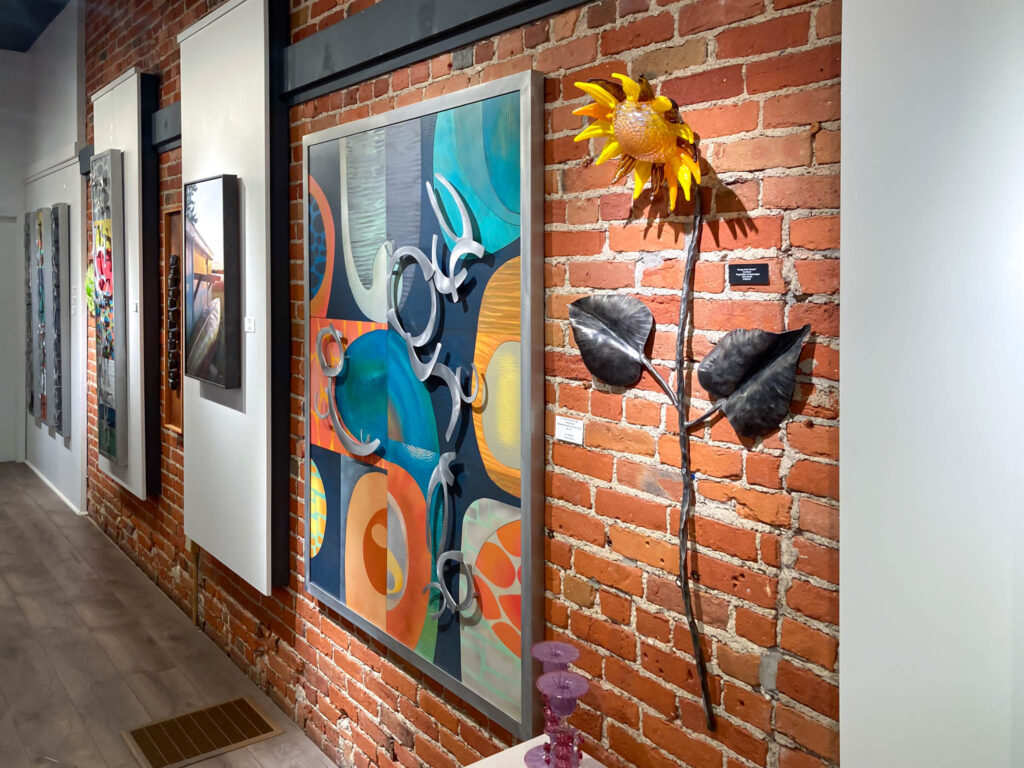 A large and colorful abstract wall art original dominating one wall of the gallery.